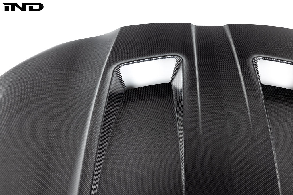 Alpha-N G8X M3 M4 carbon fiber vented hood in raw finish, exterior car part with a lightweight, vented design.