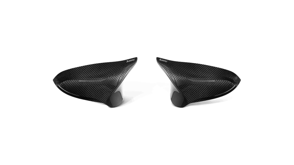 Akrapovic carbon fiber mirror cap set for BMW F8X M2C, M3, M4 exterior accessories, featuring sleek carbon fiber finish.