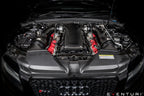 Front view of a B8 RS5 engine bay with full eventuri carbon engine cover and intake system installed on a dark background