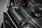 Eventuri black carbon intake system installed in engine bay of Audi C8 RS6 and RS7 performance vehicles.
