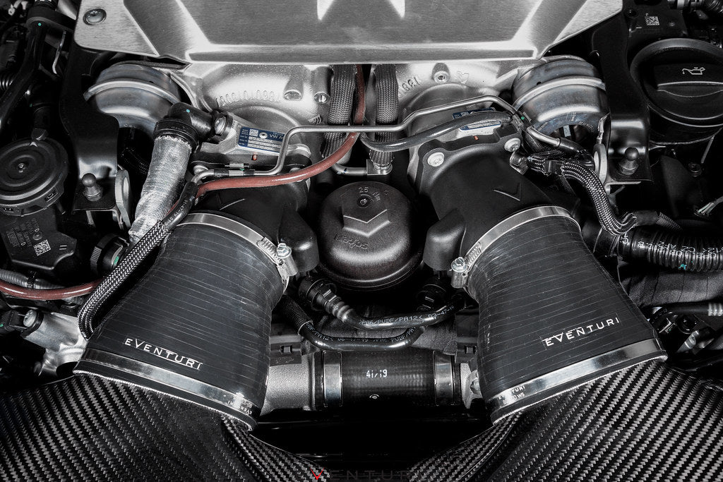Eventuri black carbon intake system installed in engine bay of Audi C8 RS6 and RS7, showcasing performance air intake components.