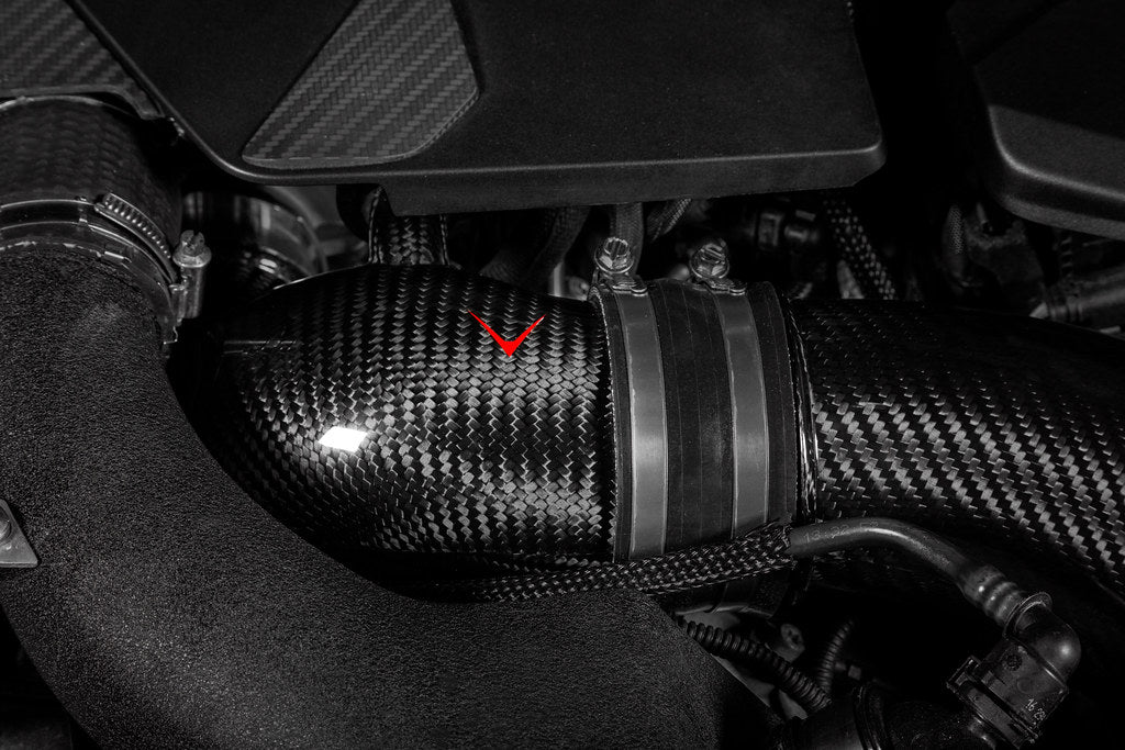 Eventuri BMW F90 M5 and M8 carbon turbo inlet set installed in engine bay, showcasing high-performance aftermarket intake components.