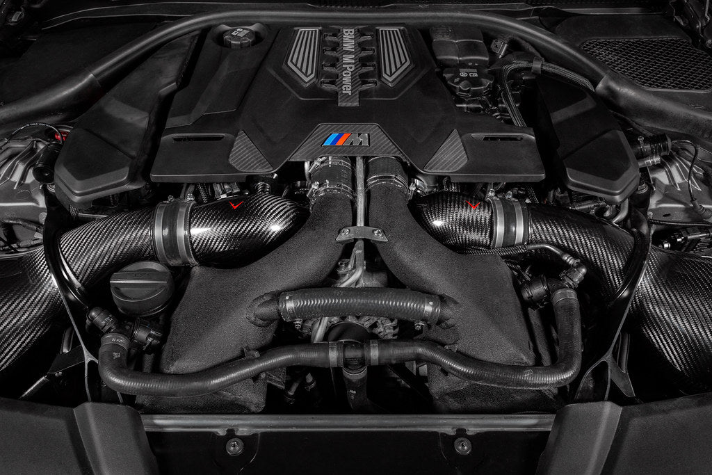 Eventuri BMW F90 M5 and M8 carbon turbo inlet set installed in engine bay for improved performance and airflow.