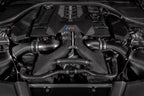 Eventuri BMW F90 M5 and M8 carbon turbo inlet set installed in engine bay for improved performance and airflow.