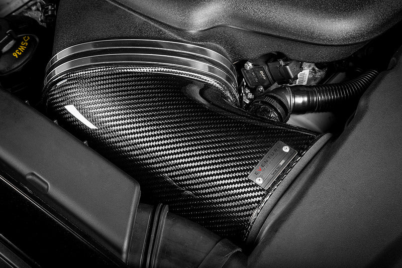 Eventuri black carbon intake system installed in BMW E9X M3 S65 engine bay, showcasing performance air intake for enhanced engine airflow.