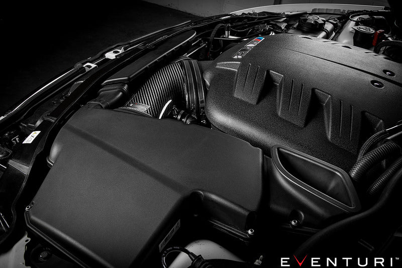 Eventuri black carbon intake system installed in BMW E9X M3 S65 engine bay, showcasing performance air intake components.