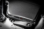 Eventuri black carbon airbox lid installed on BMW E9X M3 S65 engine for improved performance and sleek gloss finish.