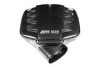 Eventuri black carbon inlet plenum for BMW E9X M3 S65 engine, glossy finish, performance auto part on white background.