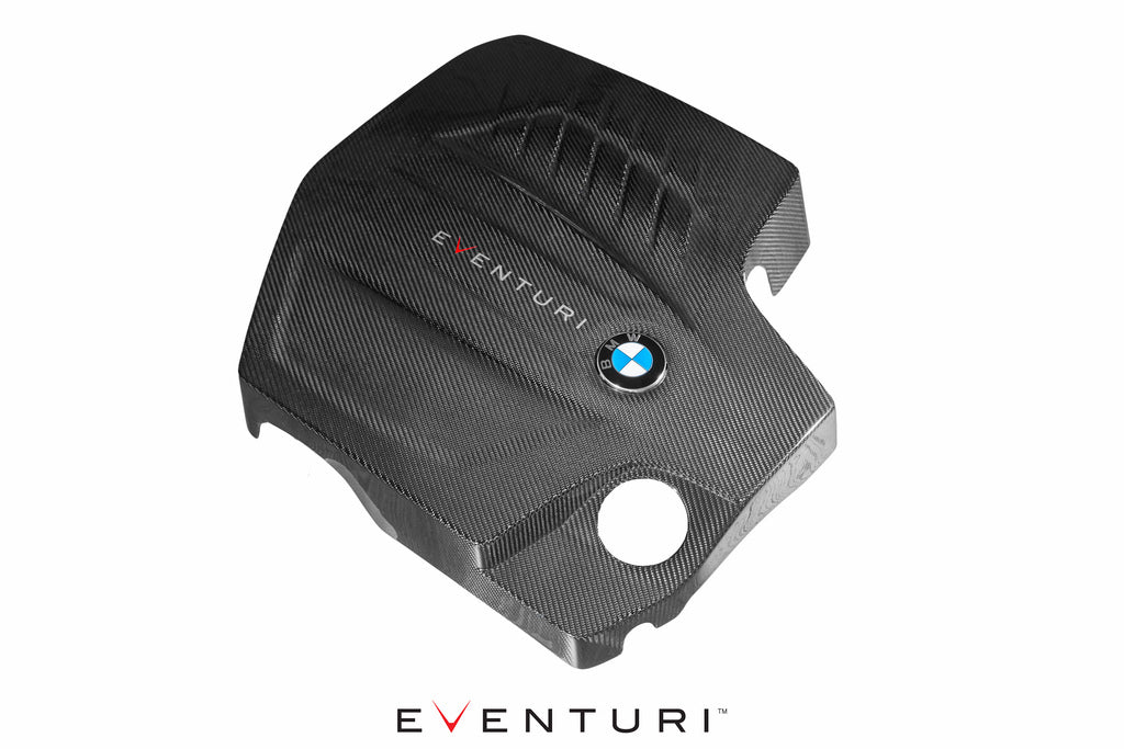 Overhead front view of black carbon BMW F-Chassis N55 engine cover by Eventuri, showcasing its sleek performance design.