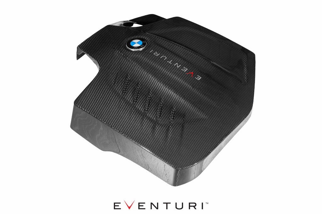 Eventuri black carbon engine cover for BMW F-Chassis N55, overhead rear view showing performance automotive design.
