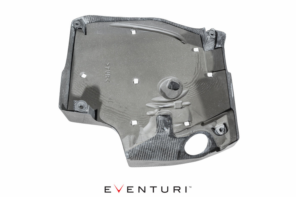 Underside view of Eventuri's BMW F-Chassis with N55 carbon fiber engine cover on white background