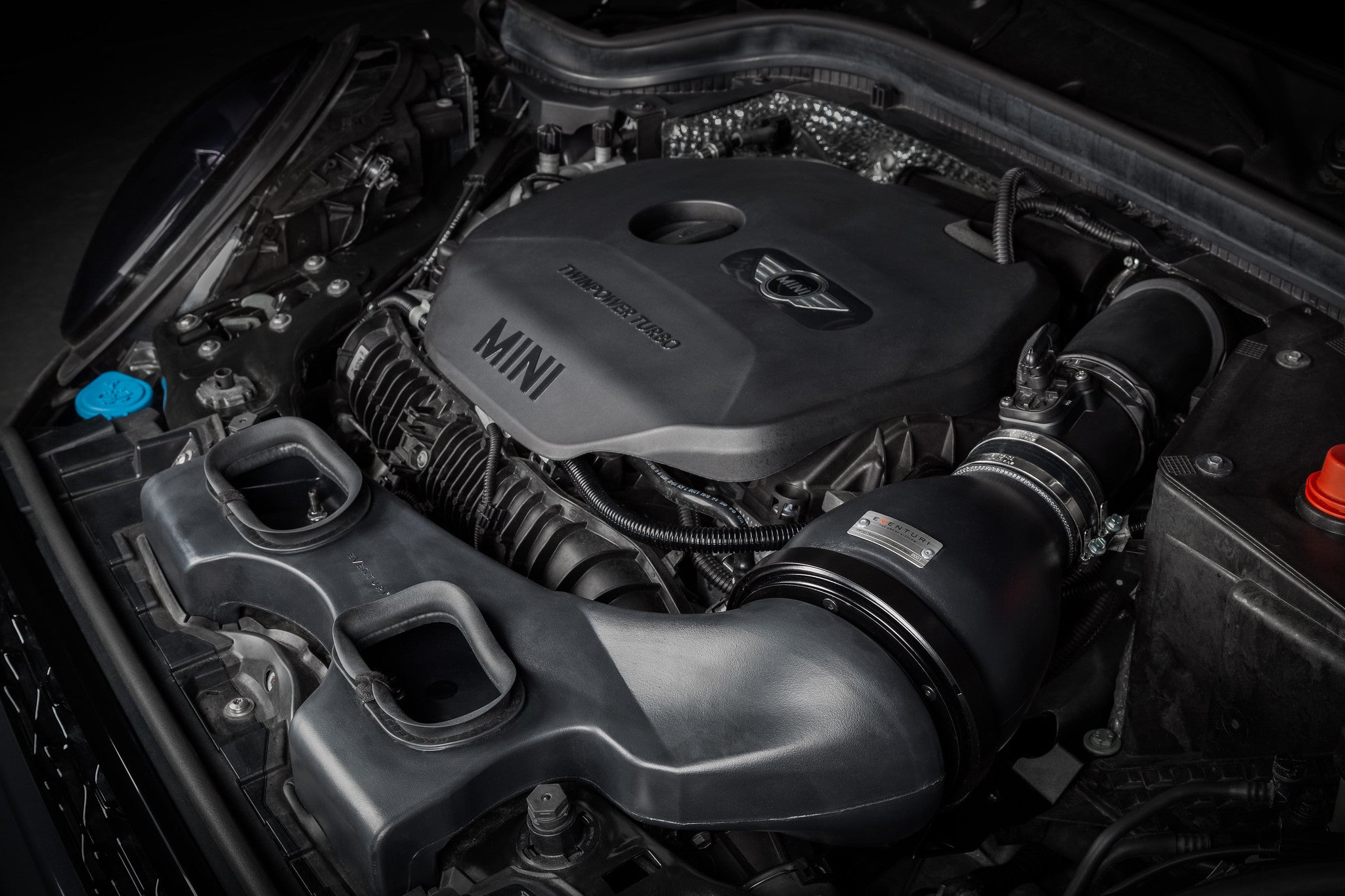 Eventuri F56 Mini Cooper S plastic intake with carbon scoop installed in engine bay, showcasing performance upgrade components.