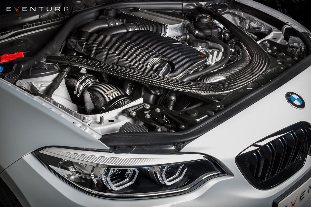 Eventuri black carbon intake system installed on BMW F87 M2 Competition and M2 CS, showcasing performance automotive parts.
