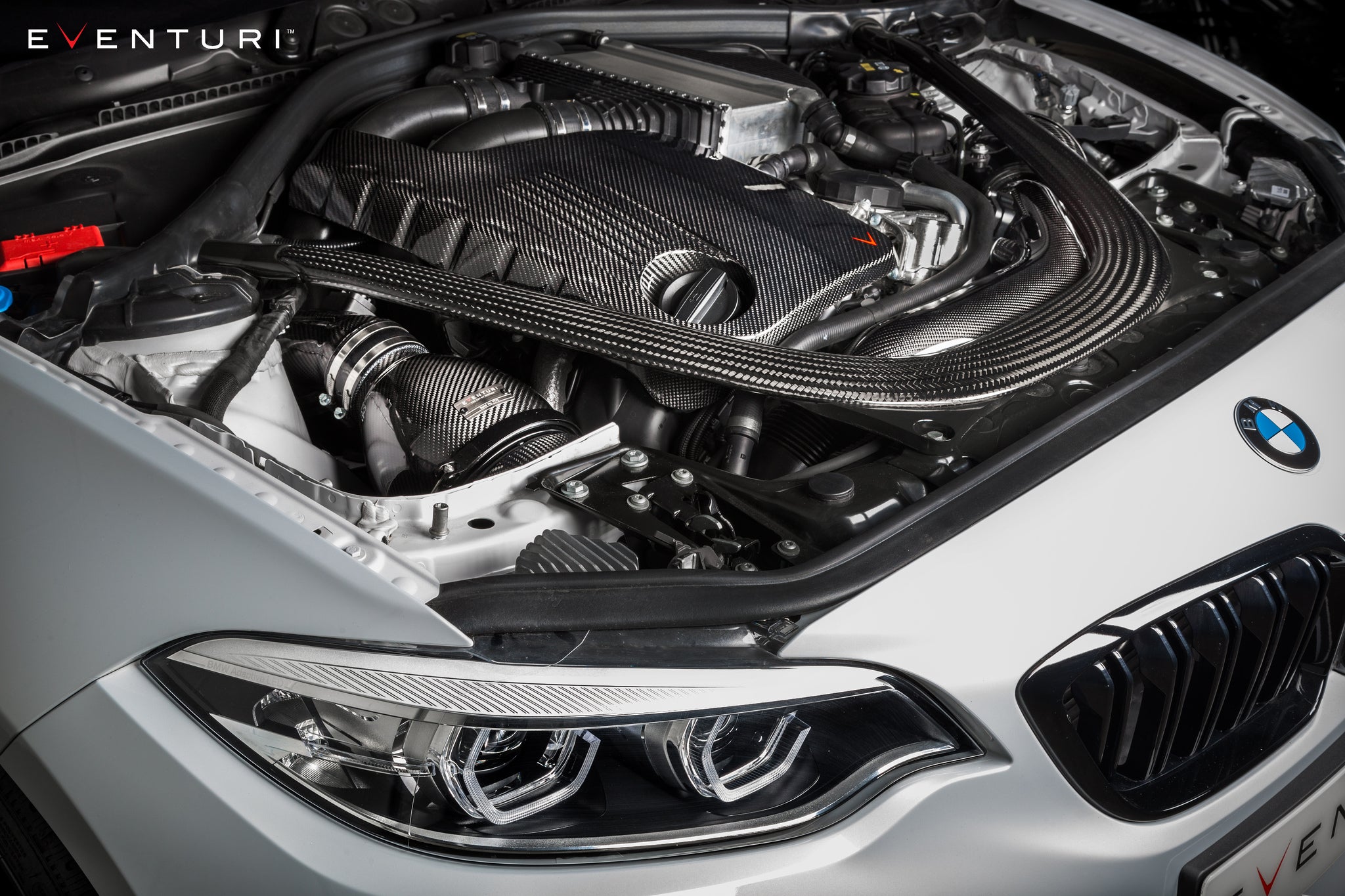 Eventuri black carbon intake system installed on BMW F87 M2 Competition and M2 CS, showcasing performance automotive parts.