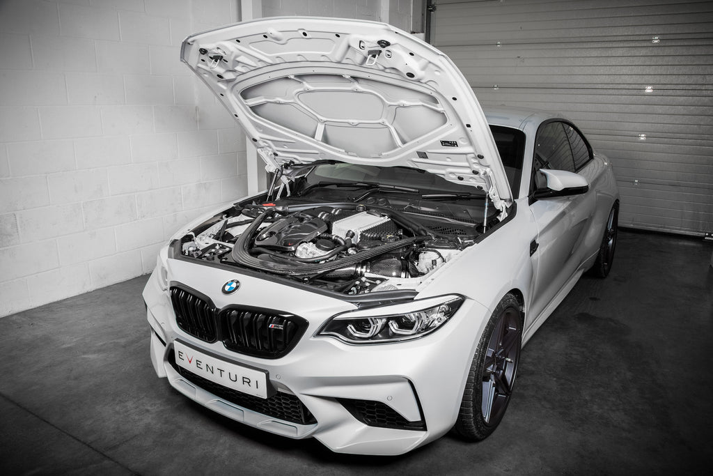 Eventuri black carbon intake system installed on BMW F87 M2 Competition and M2 CS, showcasing high-performance engine components.