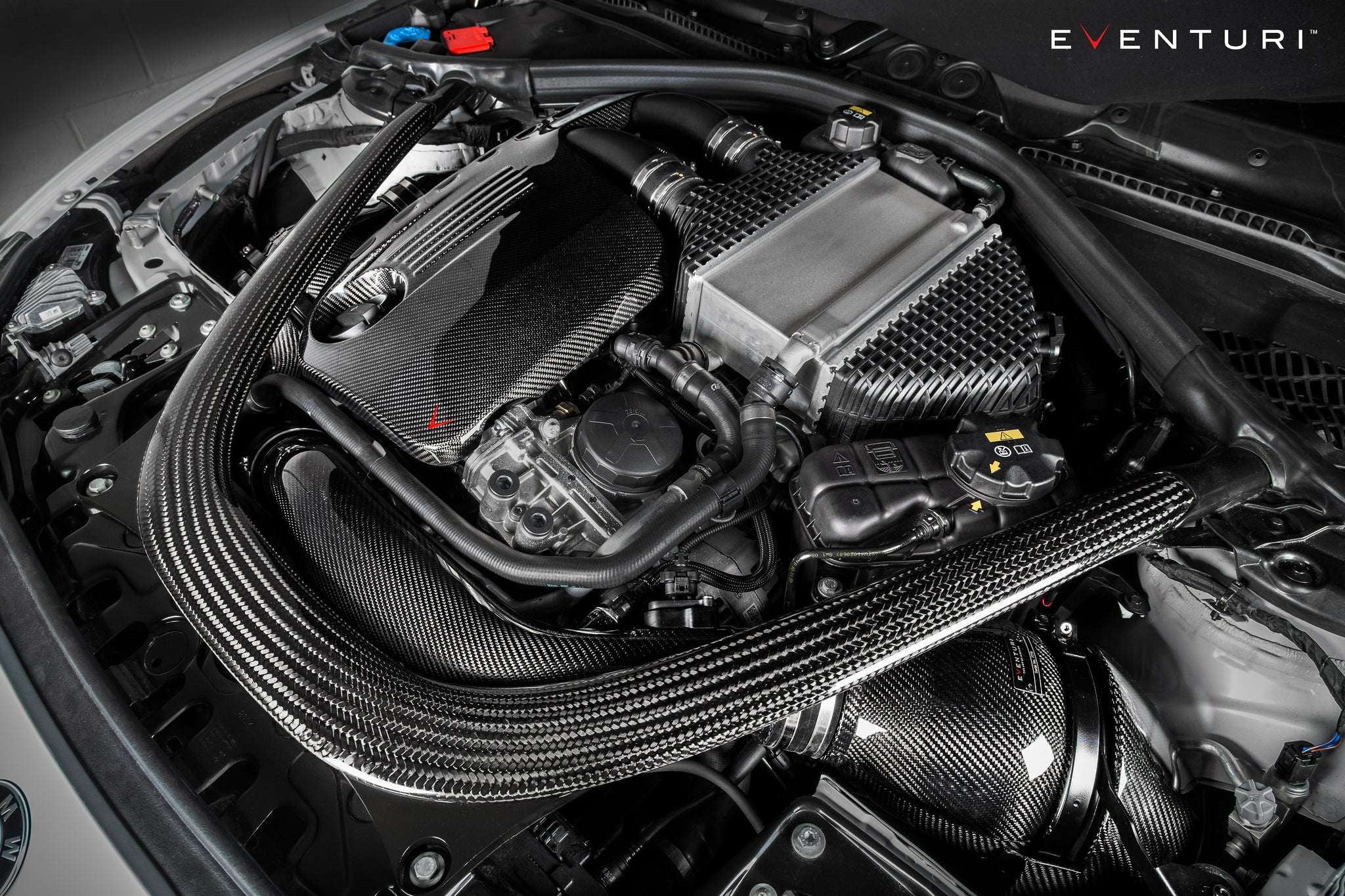 Eventuri black carbon intake system installed on BMW F87 M2 Competition and M2 CS, showcasing performance air intake.