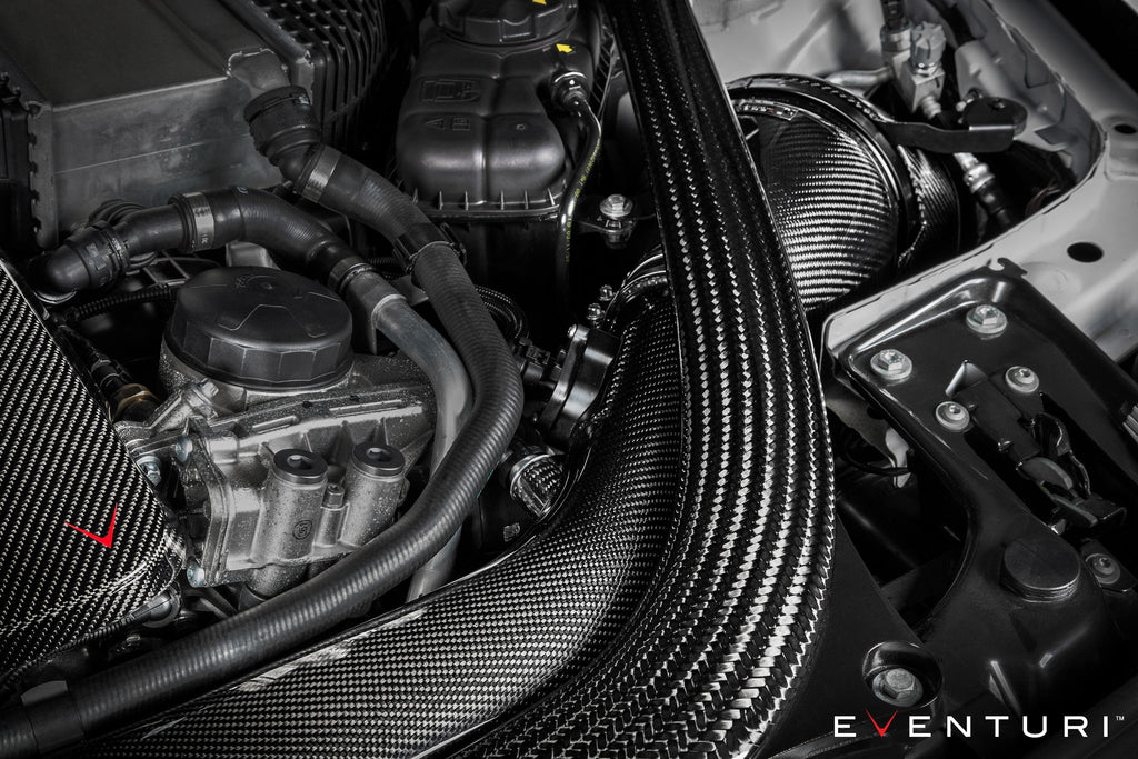 Eventuri black carbon intake system installed on BMW F87 M2 Competition and M2 CS, showcasing performance engine components.