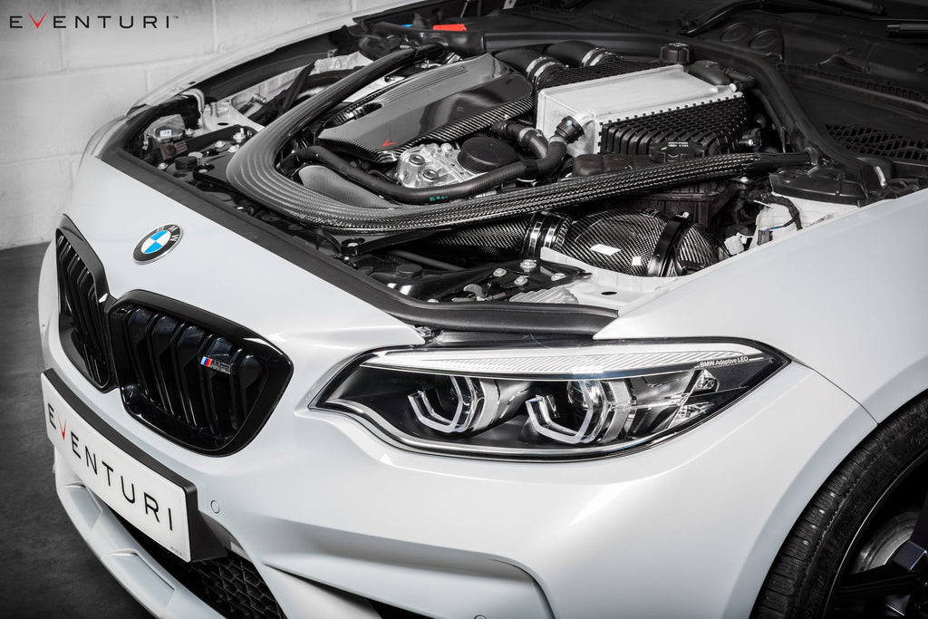 Eventuri black carbon intake system installed on BMW F87 M2 Competition and M2 CS, showcasing performance air intake design.