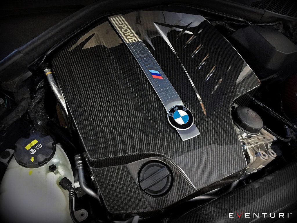 Eventuri black carbon engine cover installed on BMW F87 M2 N55, showcasing sleek exterior engine bay enhancement.