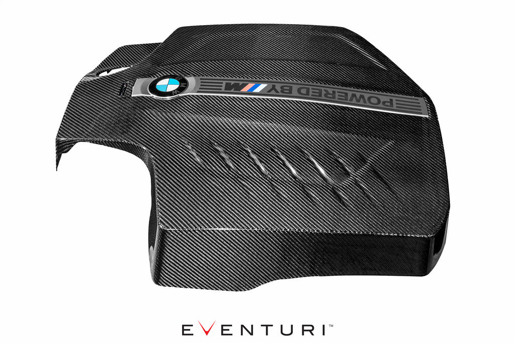 Eventuri black carbon engine cover for BMW F87 M2 N55, shown from the left profile, highlighting its sleek exterior design.