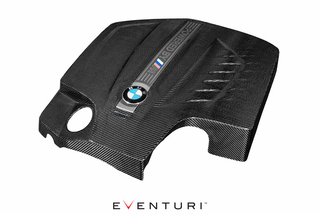 Black carbon engine cover for BMW F87 M2 N55 by Eventuri, showcasing sleek exterior design and high-quality material.