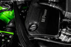 Eventuri black carbon intake system installed in engine bay of BMW F8X M3 and M4 with S55 engine, showcasing performance upgrade.