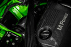 Eventuri black carbon intake system installed in engine bay of BMW F8X M3 and M4 with V2 performance upgrade.