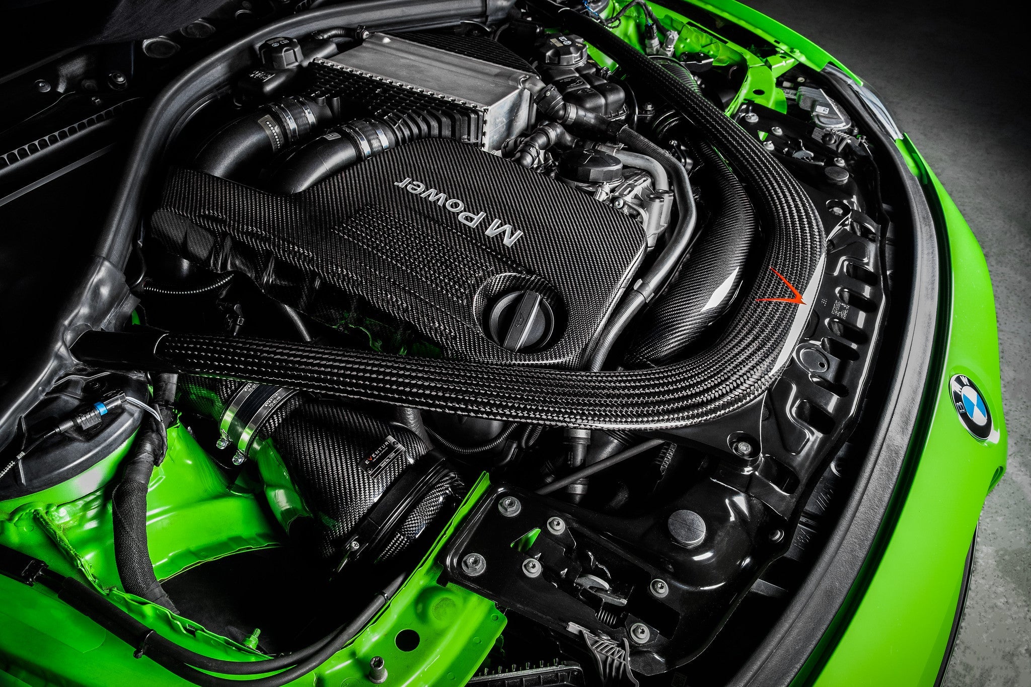 Eventuri black carbon intake system installed in engine bay on BMW F8X M3 and M4 with V2 performance upgrade