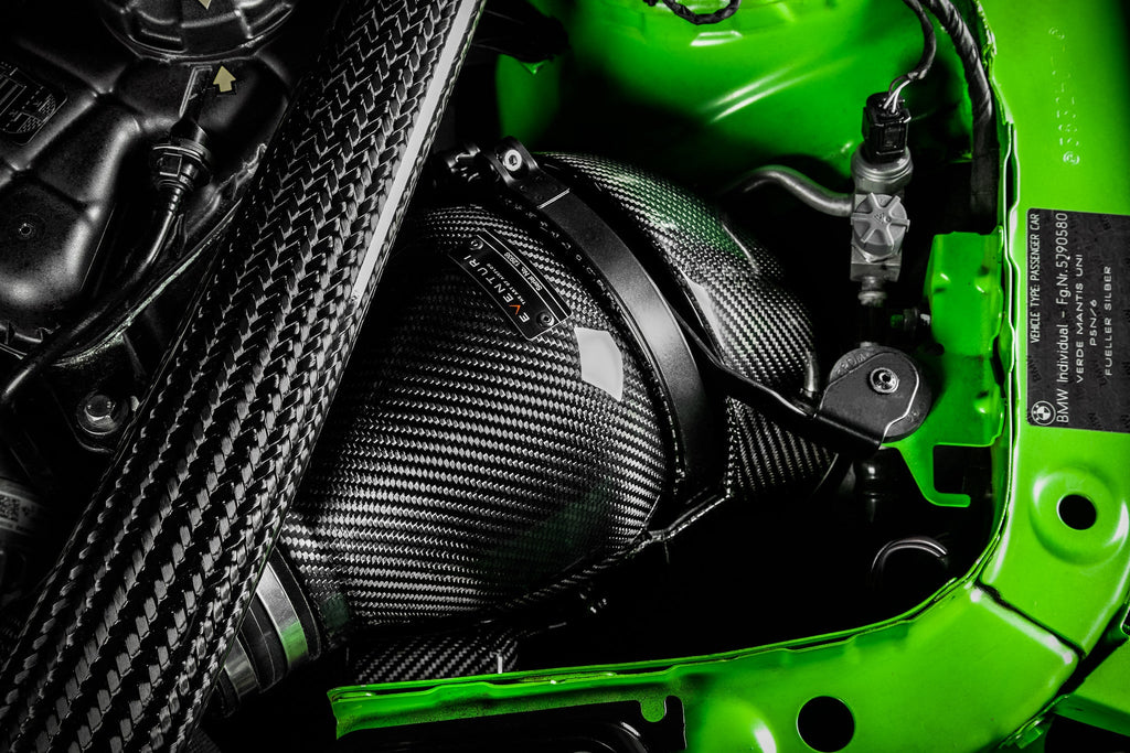 Eventuri black carbon intake system installed in engine bay of BMW F8X M3 and M4 with performance V2 upgrade.