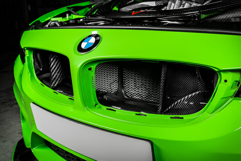 Eventuri black carbon intake system installed in engine bay of BMW F8X M3 and M4 S55 performance engine.