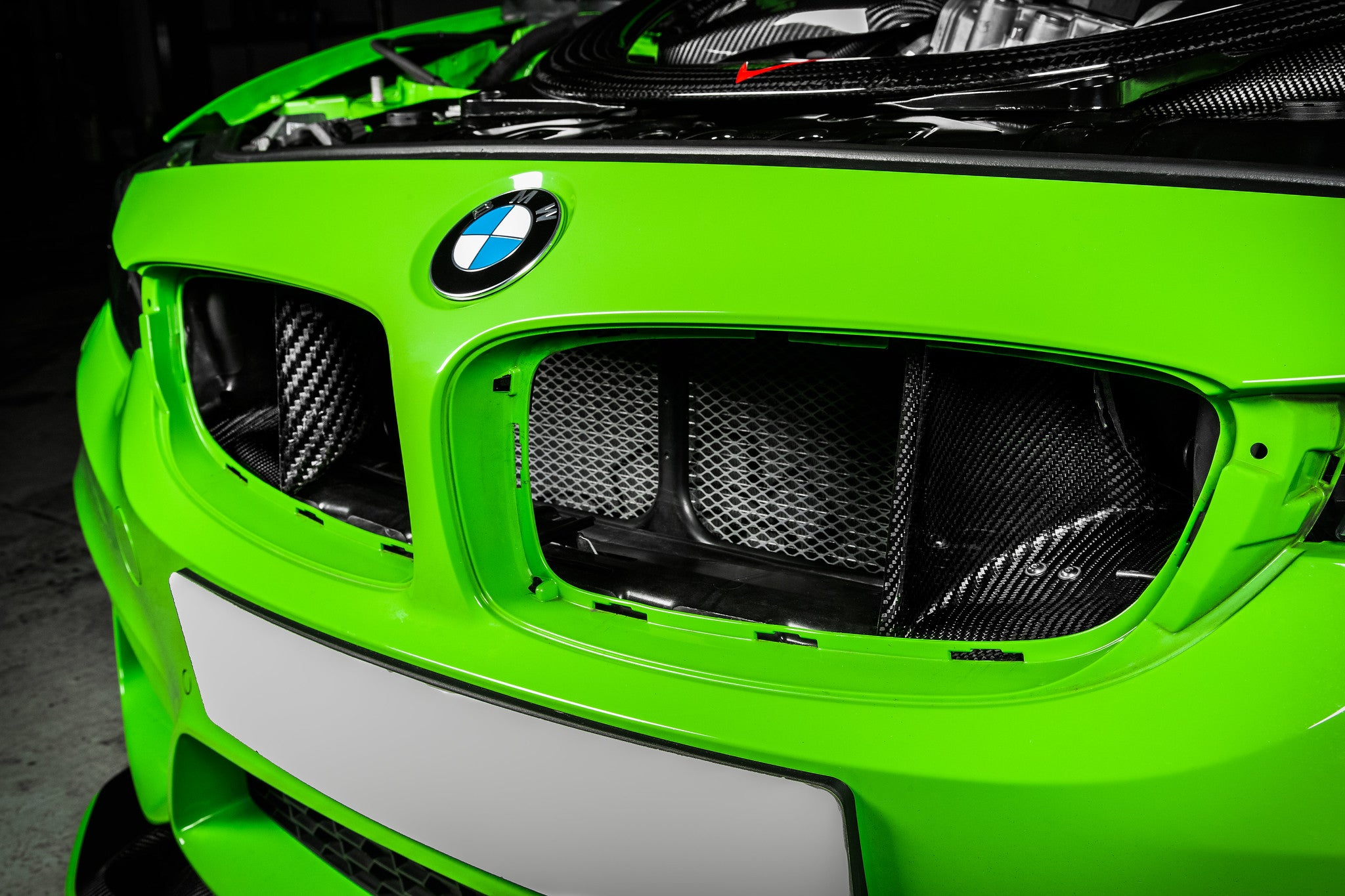 Eventuri black carbon intake system installed in engine bay of BMW F8X M3 and M4 S55 performance engine.