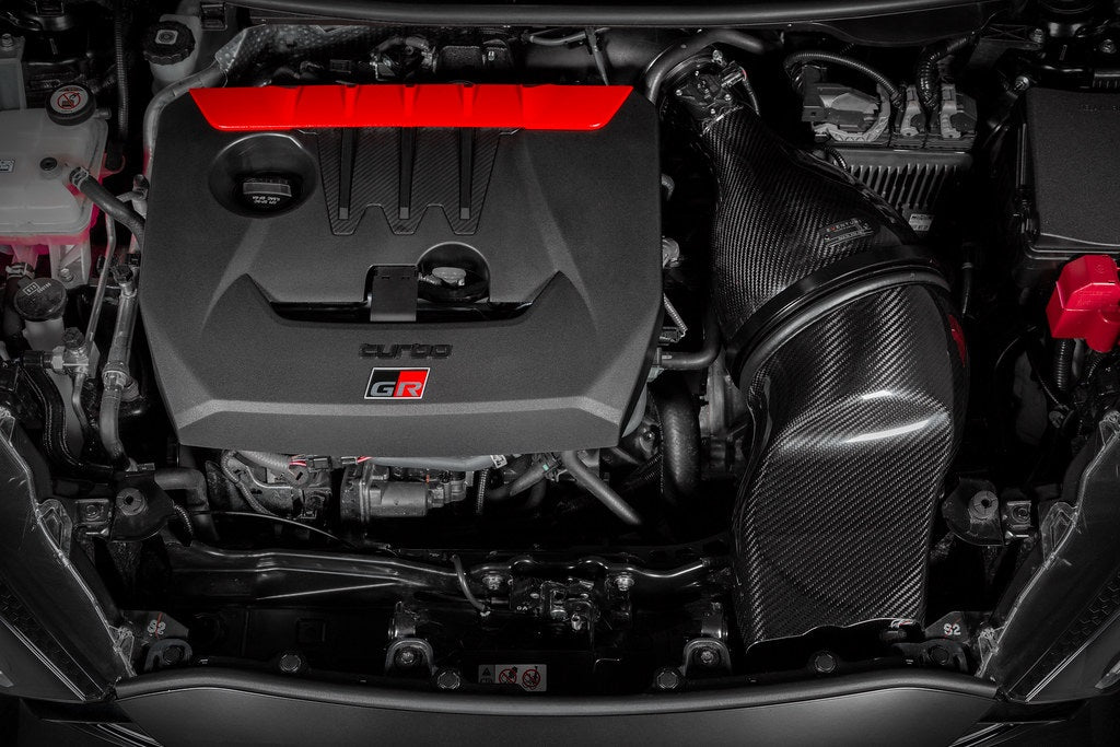 Eventuri GR Yaris carbon intake system installed, showcasing glossy, high-performance automotive air intake for enhanced engine airflow.