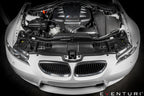 Eventuri black carbon airbox lid for BMW E9X M3 S65 engine bay, glossy performance upgrade for improved airflow and style.