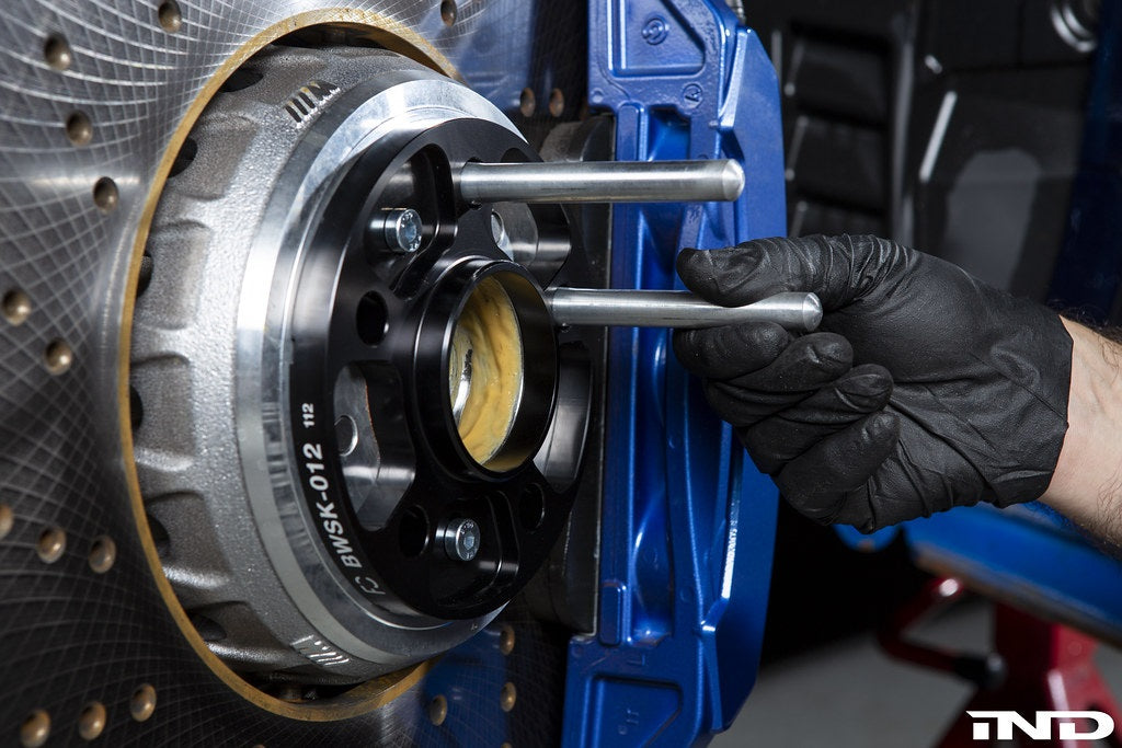 FC BMW / Supra 5x112 wheel spacer kit installed on hub with mounting studs, showing the spacer's fit and finish
